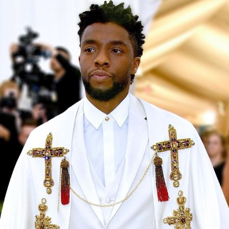 Chadwick Boseman wears a full white Versace Outfit for an event